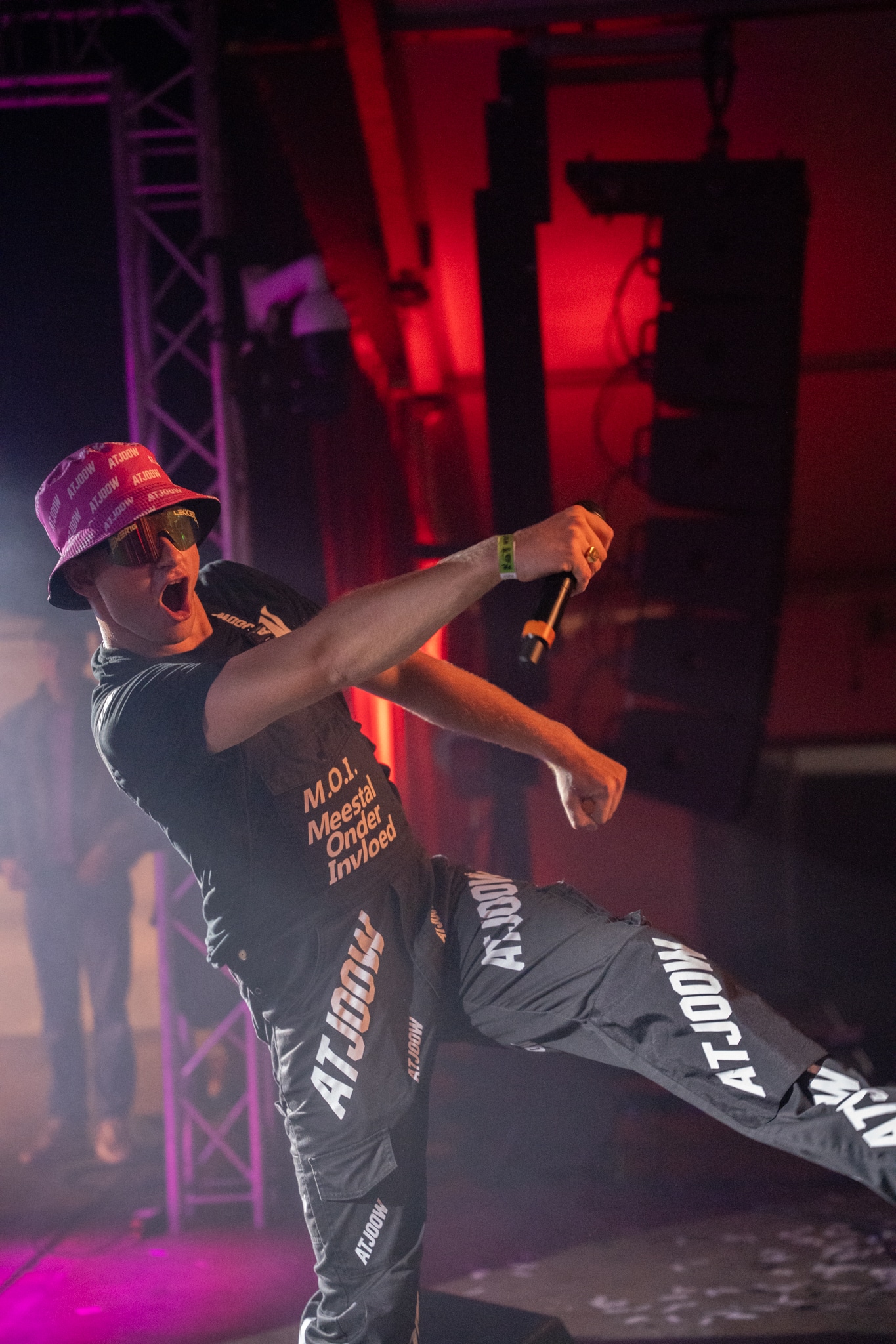 Artist in a pink ATJOOW hat in a dynamic pose