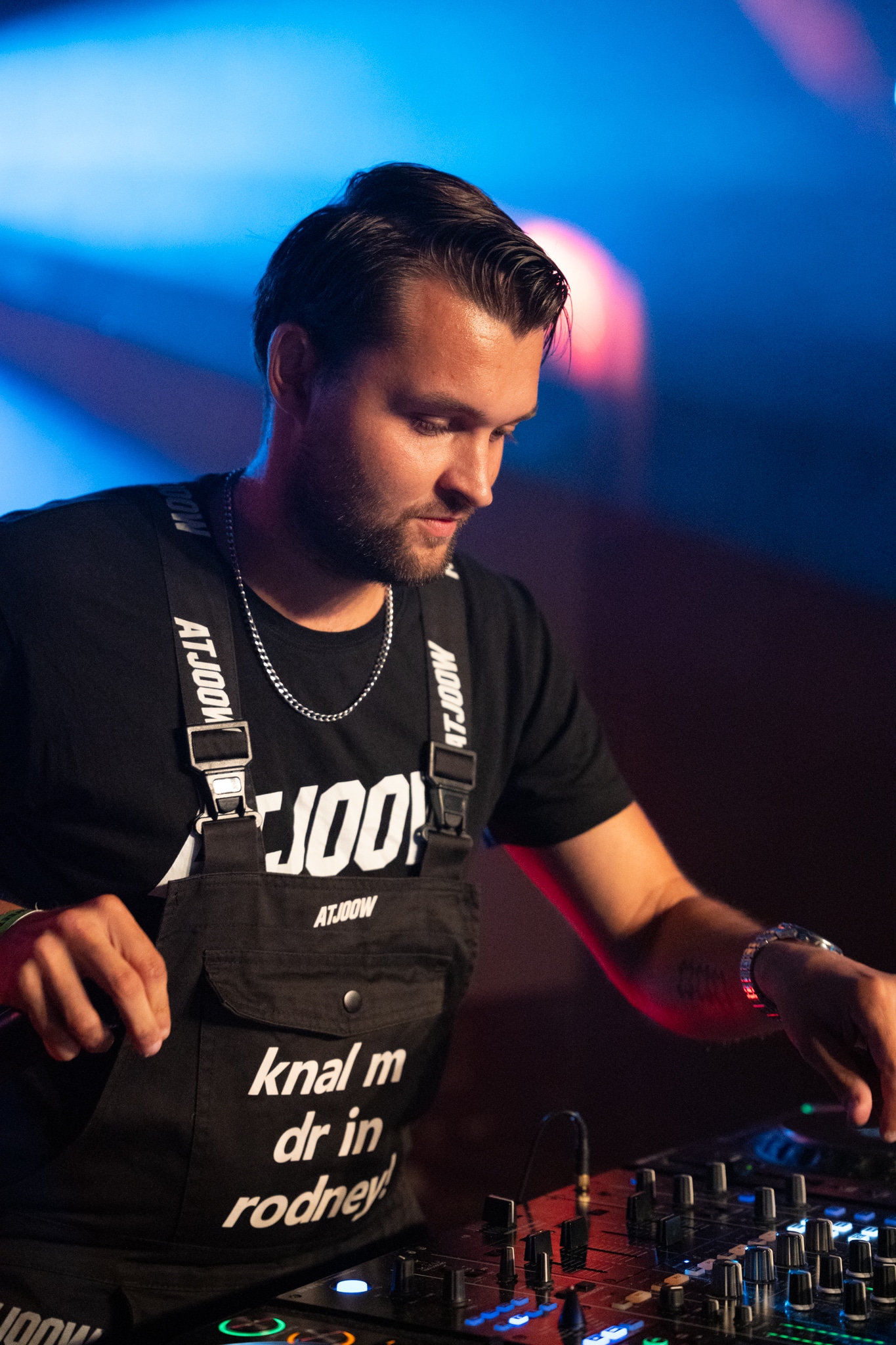 Performer focused at the DJ mixer